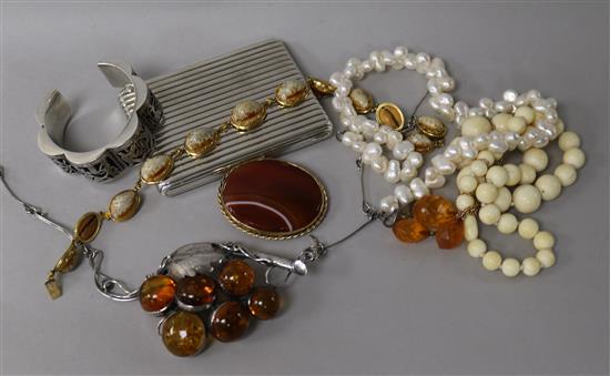 A white metal cigarette case, a white metal Egyptian bangle, a silver and amber necklet etc.